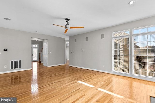 unfurnished living room with visible vents, baseboards, and light wood-style floors