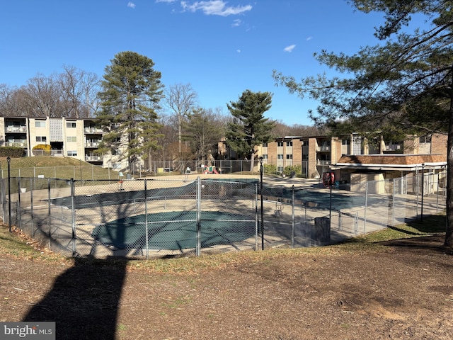 view of sport court with fence