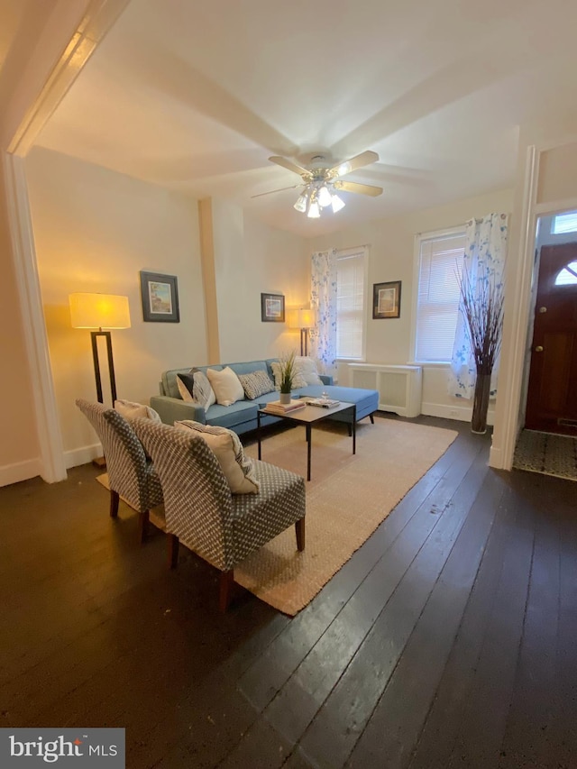 living room with radiator, ceiling fan, and dark wood-type flooring