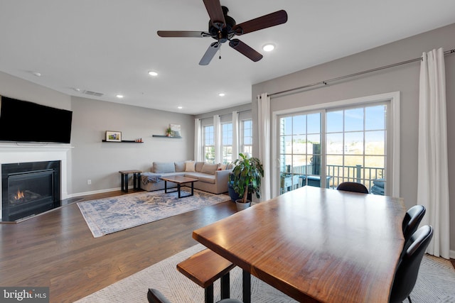 dining area with wood-type flooring and ceiling fan