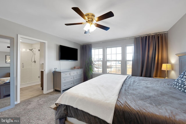 bedroom with ceiling fan, light carpet, and ensuite bath