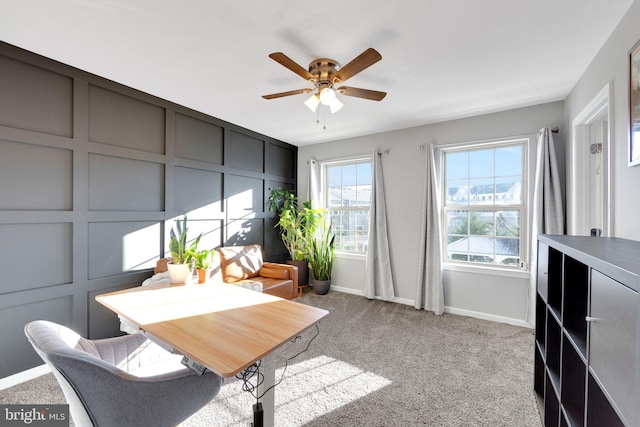 carpeted dining space with ceiling fan and a wealth of natural light