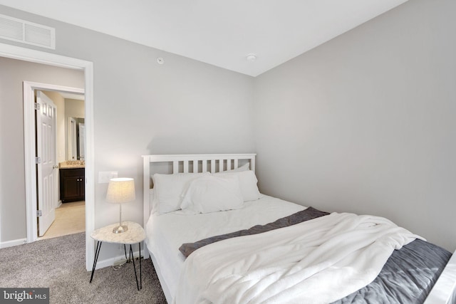 carpeted bedroom featuring ensuite bathroom