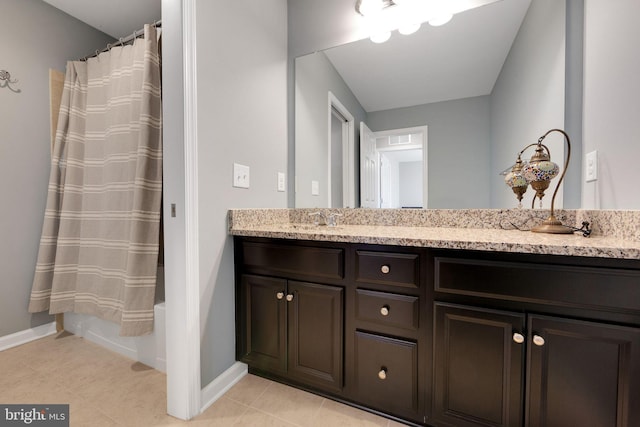 bathroom featuring tile patterned flooring, vanity, and shower / bath combo