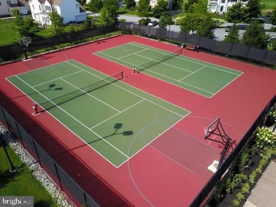 view of tennis court with basketball hoop