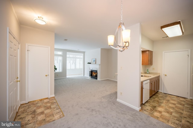 kitchen with white dishwasher, decorative light fixtures, light carpet, and a chandelier