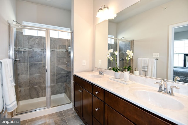 bathroom with tile patterned flooring, vanity, and a shower with shower door