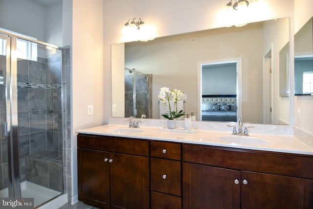 bathroom featuring a healthy amount of sunlight, a shower with shower door, and vanity