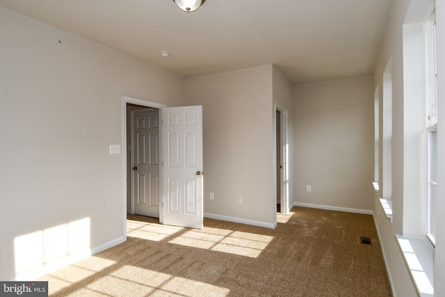 unfurnished bedroom featuring light colored carpet