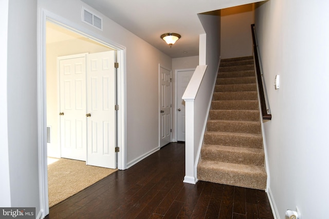 stairs featuring wood-type flooring