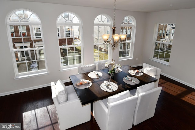 dining room featuring dark hardwood / wood-style flooring and a notable chandelier