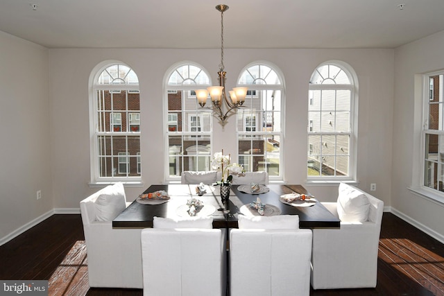 dining area featuring an inviting chandelier and dark hardwood / wood-style flooring