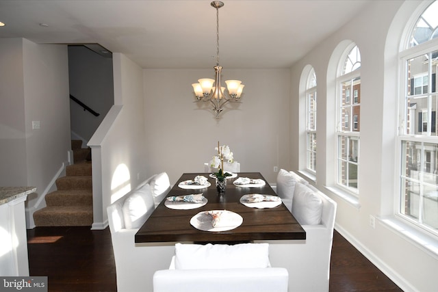 unfurnished dining area featuring dark hardwood / wood-style flooring and an inviting chandelier