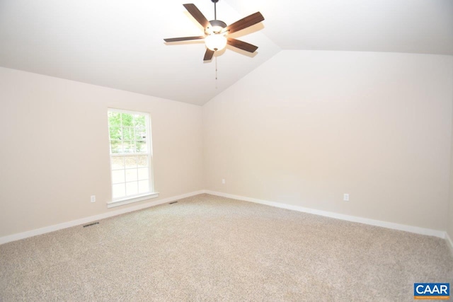 carpeted empty room featuring ceiling fan and vaulted ceiling