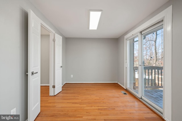 empty room with light hardwood / wood-style floors