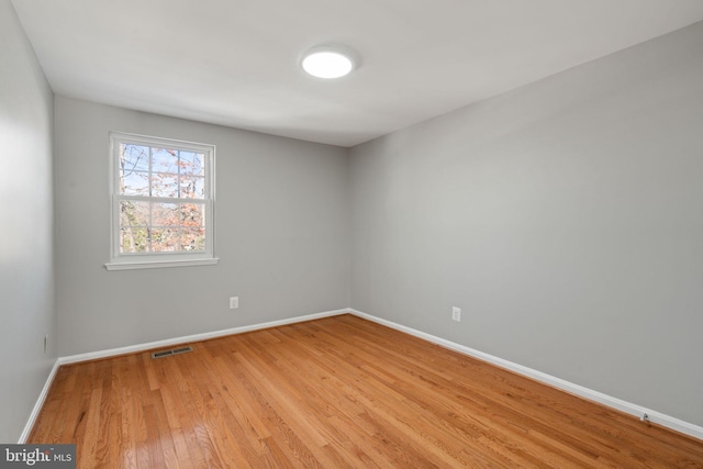 spare room featuring light hardwood / wood-style floors