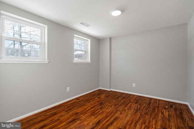 empty room with hardwood / wood-style floors