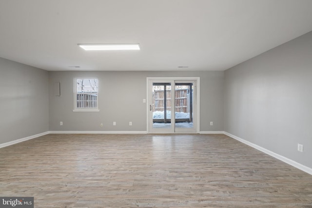 unfurnished room with light wood-type flooring