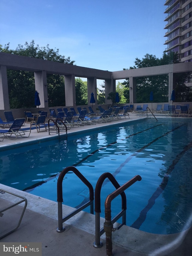 view of swimming pool with a patio