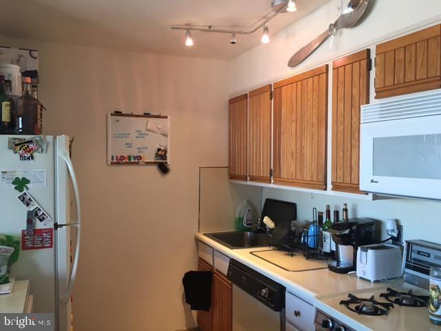 kitchen with sink and white appliances