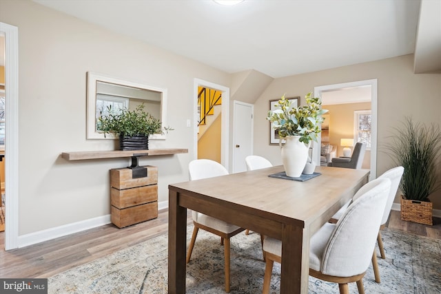 dining area with baseboards and wood finished floors