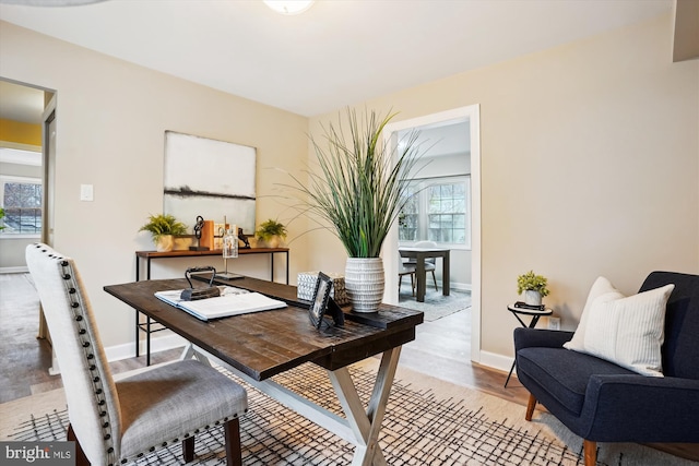 home office with light wood-style floors and baseboards