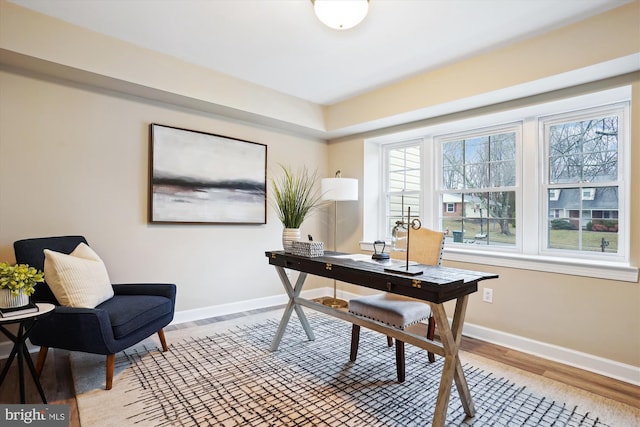 office space with light wood finished floors and baseboards