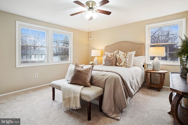 bedroom featuring baseboards, a ceiling fan, and light colored carpet