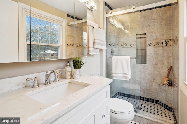 full bath with toilet, a shower stall, and vanity