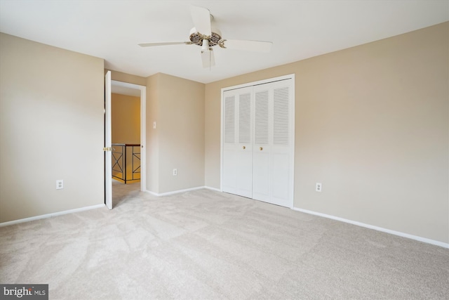 unfurnished bedroom featuring carpet floors, ceiling fan, baseboards, and a closet