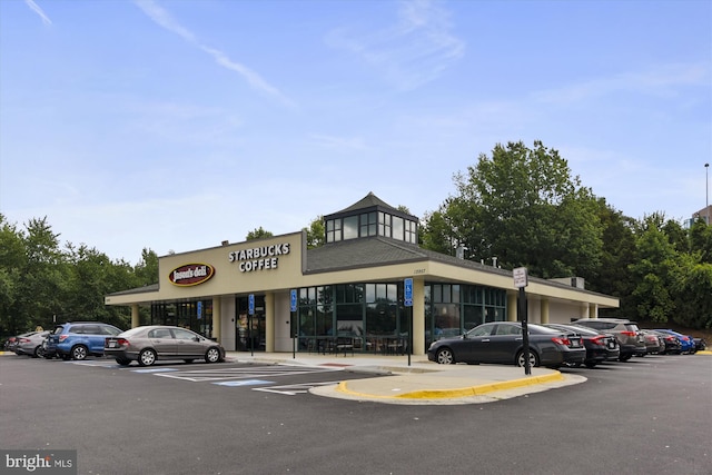 view of property featuring uncovered parking