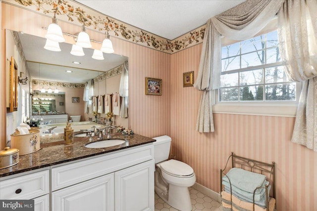 bathroom with vanity, tile patterned floors, a textured ceiling, and toilet