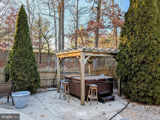 view of patio / terrace with a hot tub and a pergola