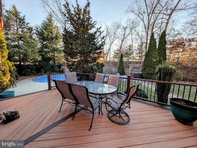 deck featuring a covered pool