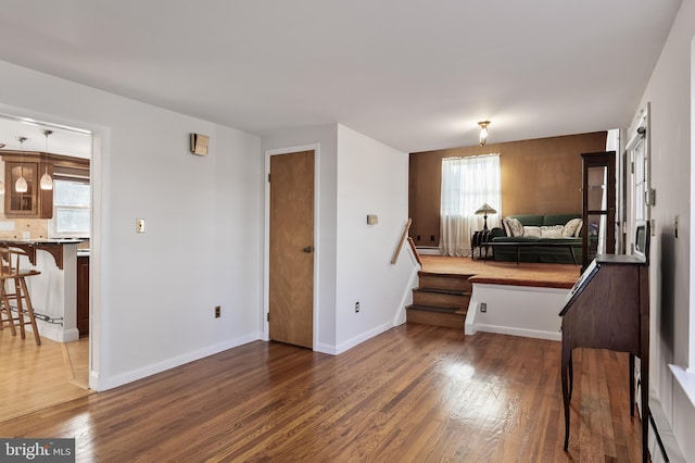 bedroom with dark wood finished floors and baseboards