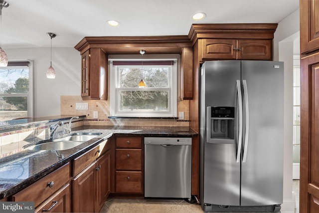 kitchen featuring pendant lighting, tasteful backsplash, recessed lighting, appliances with stainless steel finishes, and a sink