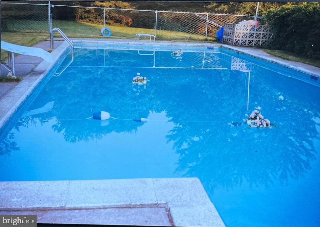 view of swimming pool featuring a water slide