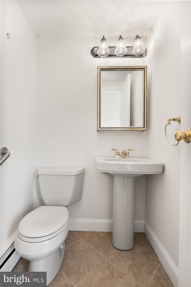 bathroom with toilet and baseboards