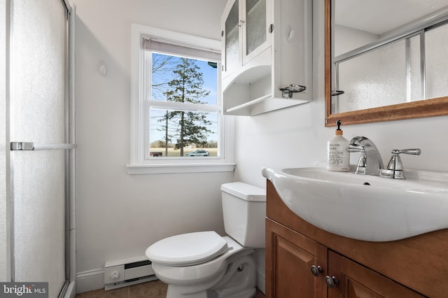 bathroom featuring a baseboard heating unit, toilet, an enclosed shower, and vanity