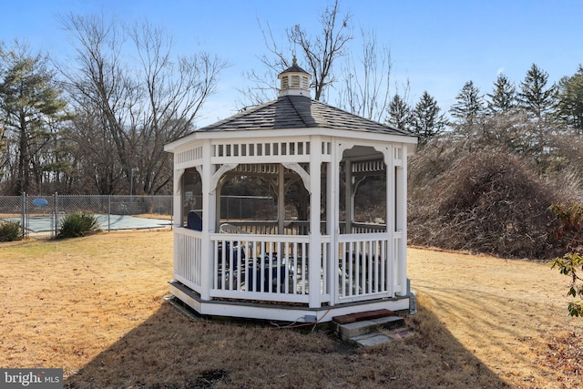 view of yard featuring a gazebo, a swimming pool, and fence