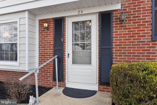 property entrance featuring brick siding