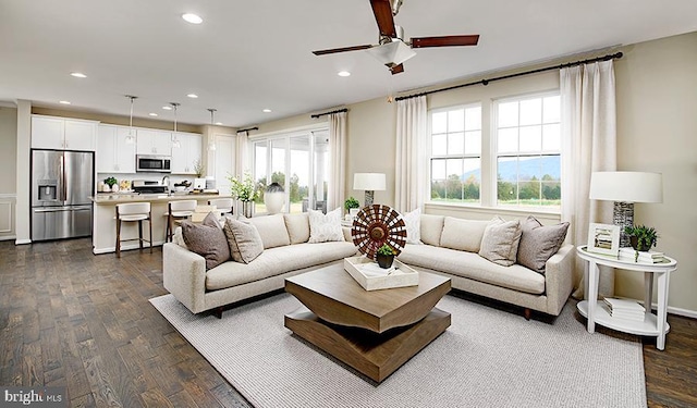 living room with dark hardwood / wood-style floors and ceiling fan