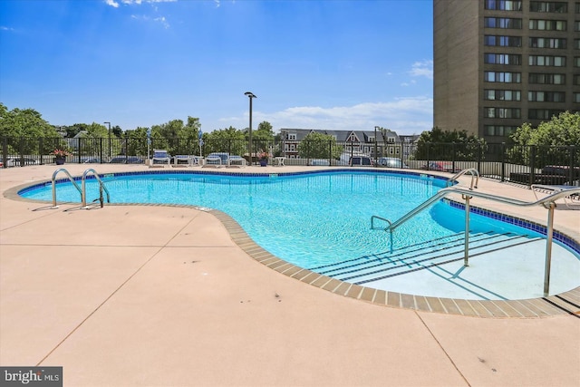 view of swimming pool with a patio area