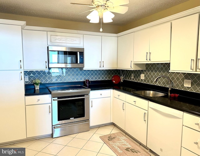 kitchen with white cabinetry, sink, stainless steel appliances, and a textured ceiling