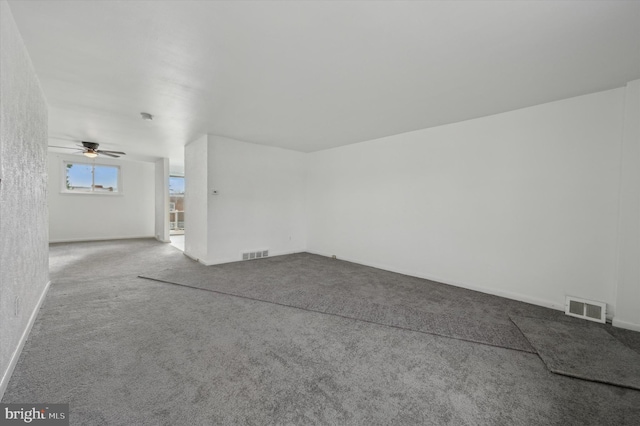 spare room featuring ceiling fan and carpet floors