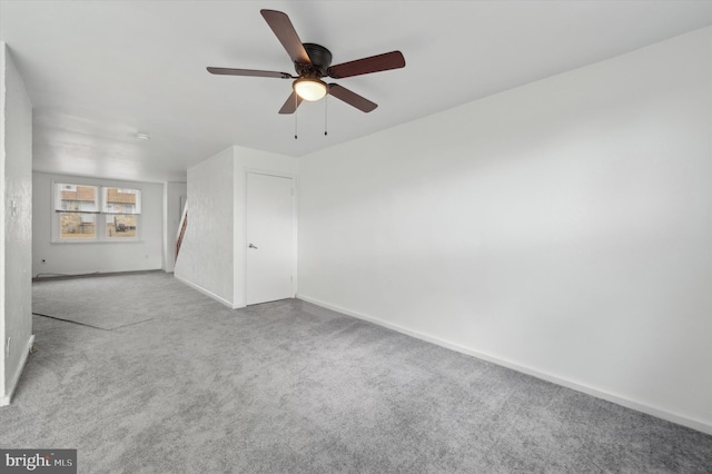 empty room with light colored carpet and ceiling fan