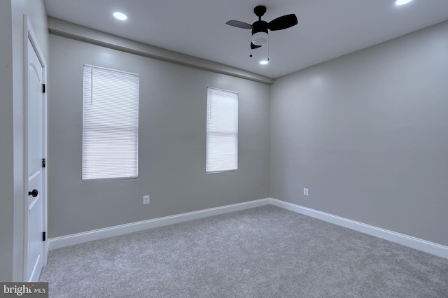 unfurnished room with ceiling fan, a wealth of natural light, and carpet flooring