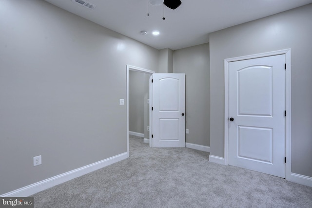 carpeted spare room with ceiling fan