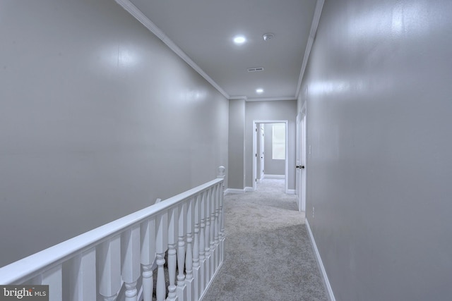 hall with light colored carpet and crown molding