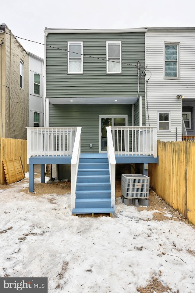 back of house with a deck and central air condition unit